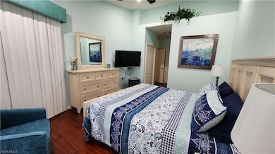 Bedroom with dark wood-style floors