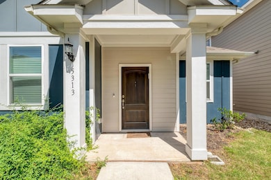 Property entrance with covered porch and stucco s