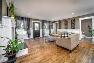 Living Room with hardwood floors and wood burning fireplace.