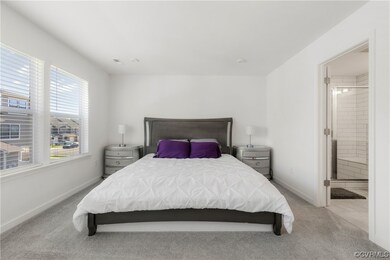 Primary bedroom with walk-in closet and en-suite bathroom.