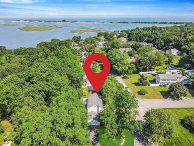 Aerial overview of property's location with a nearby body of water
