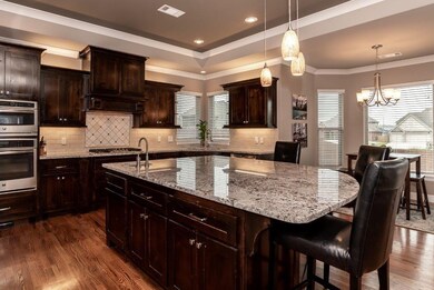 Granite countertops.  Island features prep sink and has lots of storage.  Kitchen also has breakfast area.