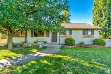 Single story home with a front yard, brick siding, and a shingled roof