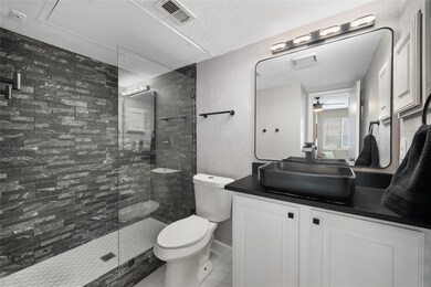 Bathroom with ceiling fan, a shower with door, toi