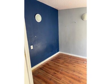 Empty room featuring hardwood / wood-style floorin
