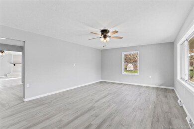 Living room with new flooring, paint and lighting