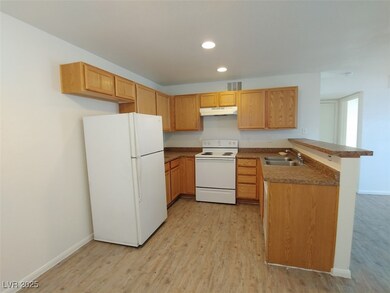 Kitchen with sink, kitchen peninsula, white applia