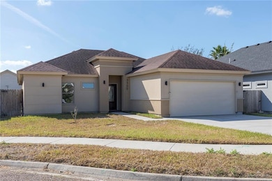 View of front of property featuring roof with shingles, driveway, an attached garage, and stucco siding