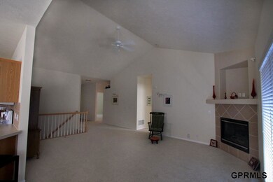 Living room has double window looking out to large deck.