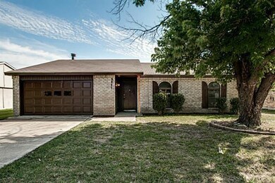 Single story home with a front yard and a garage
