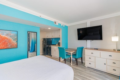 Bedroom featuring crown molding and light wood-typ