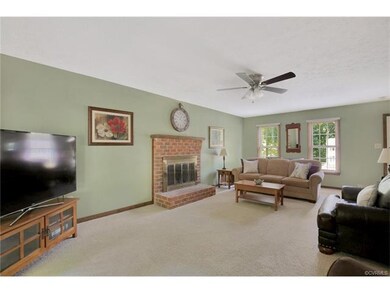 Large family room with brick fireplace, ceiling fa