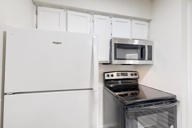 Kitchen featuring stainless steel microwave, black