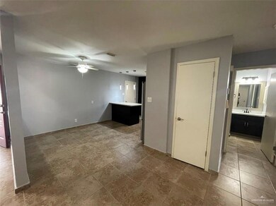 Unfurnished living room featuring ceiling fan and sink