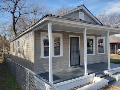 View of front of home featuring a porch and fence