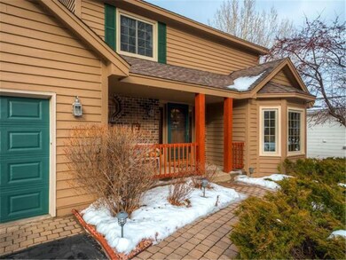 Manicured front entrance features paver stones and