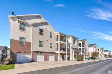 View of property with a residential view and an attached garage