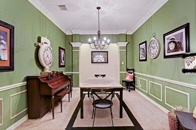The formal dining features custom trim & crown molding, 