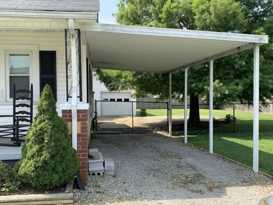 Drive thru carport into fenced back yard and garage area