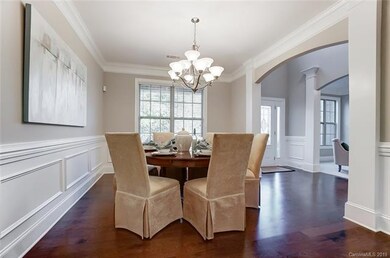 Formal Dining Room with arched entries, wood floor