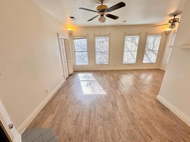 Unfurnished room with a ceiling fan and light woo