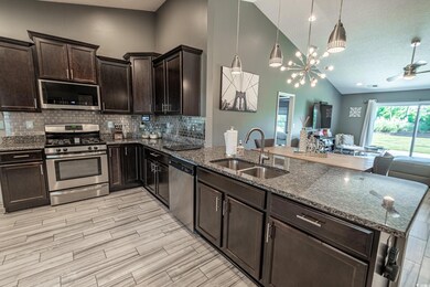 Kitchen with pendant lighting, tasteful backsplash