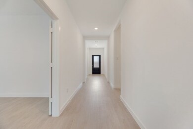 Hall featuring light wood-style floors and recessed lighting