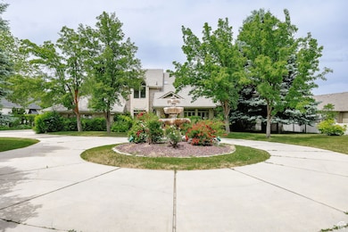 Obstructed view of property with curved driveway, a tiled roof, and a front yard