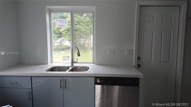 Kitchen with window and door to outside private patio