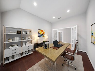 Virtually Staged. To the left of the entry hallway is the spacious private study with vaulted ceiling and glass paned French door.