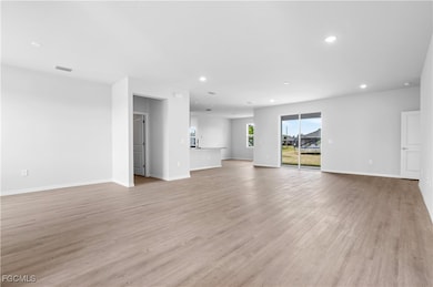 Unfurnished living room featuring recessed lighting and light wood-style floors