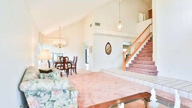 Formal living room with view of stair case and for