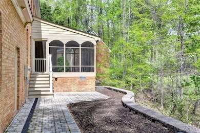 View of yard with a sunroom and a wooded view