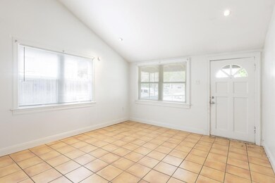 Entrance foyer with recessed lighting, baseboards