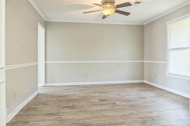 Empty room featuring wood finished floors, ornamen