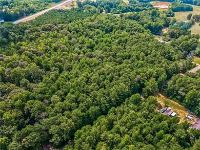 Birds eye view of property with a forest view