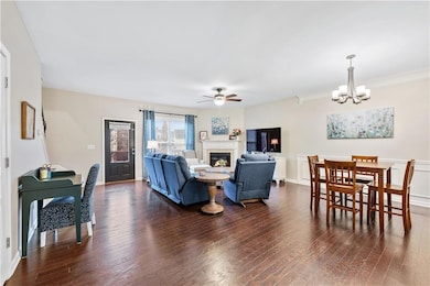 Living area featuring ceiling fan with notable cha