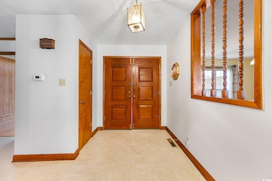 Entryway featuring baseboards, a textured ceiling,