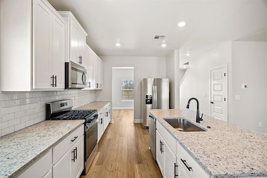 Meticulously designed kitchen featuring abundant storage, expansive counter space, and elegant matte black finishes for a modern, upscale touch!