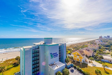 Birds eye view of property with a water view and a