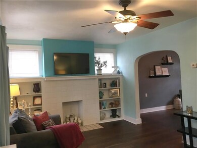 Spacious living room with original hardwood floors