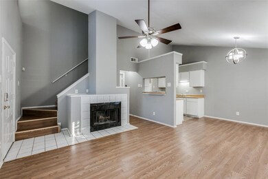 Living room featuring a fireplace, vaulted ceiling