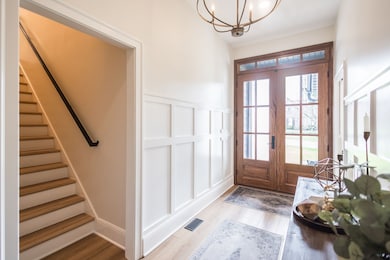 Foyer view of large double front doors in antique walnut