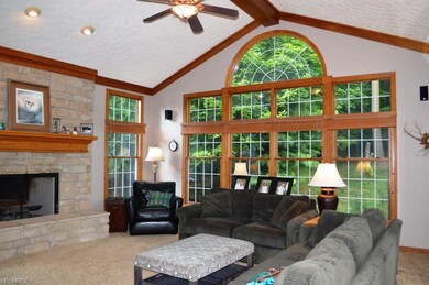 Stunning cathedral family room boasts 3 walls of w