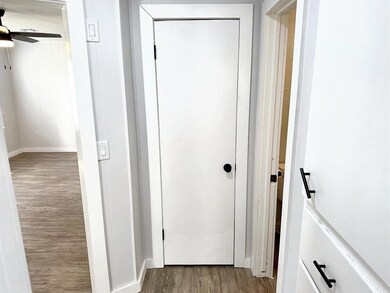 Doorway to outside featuring ceiling fan and wood-type flooring