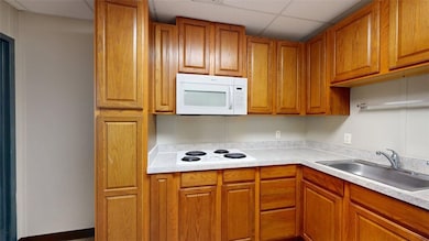 Kitchen featuring light countertops, white applian