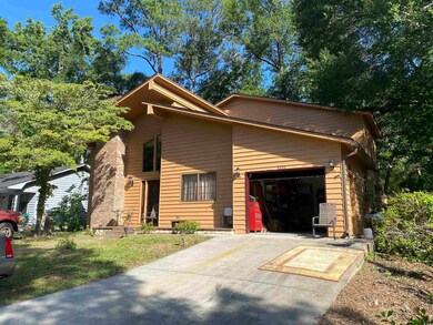 View of front facade featuring a garage and driveway