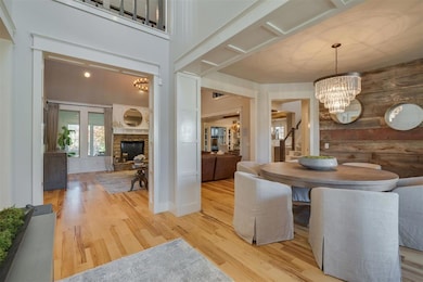 Dining area featuring a notable chandelier, stairs
