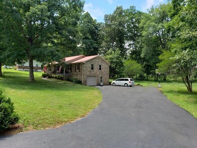 Recently re-sealed blacktop driveway with plenty of parking area