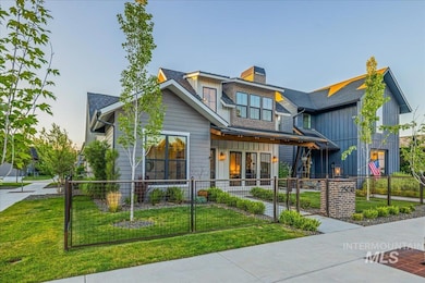 Contemporary house with a fenced front yard, a chimney, board and batten siding, and a shingled roof